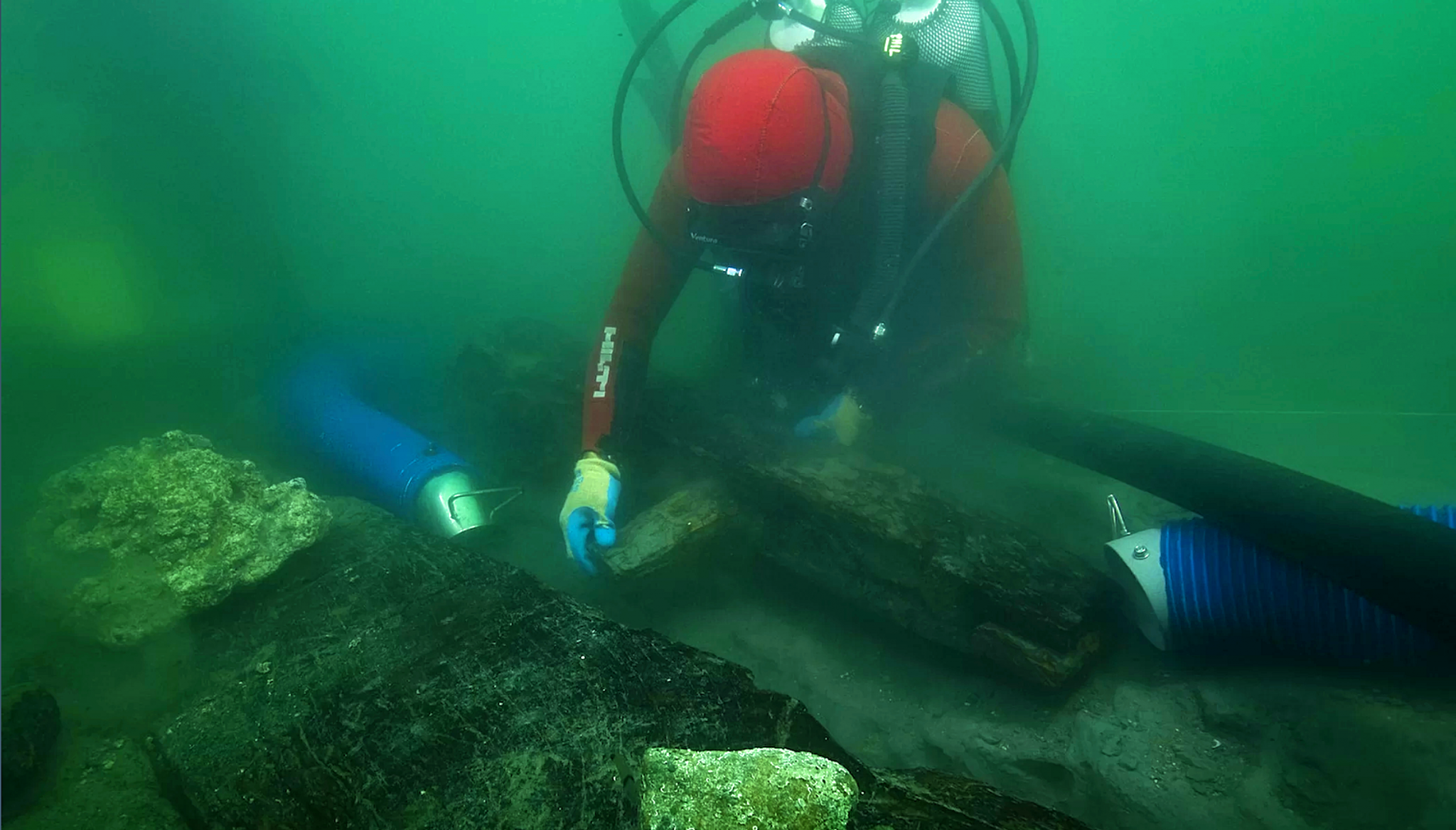 An archaeologist examines how the ancient vessels keel was put together