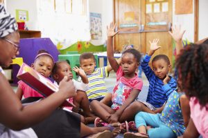 BLACK-PRESCHOOLERS-WITH-TEACHER - Children Reading Listening